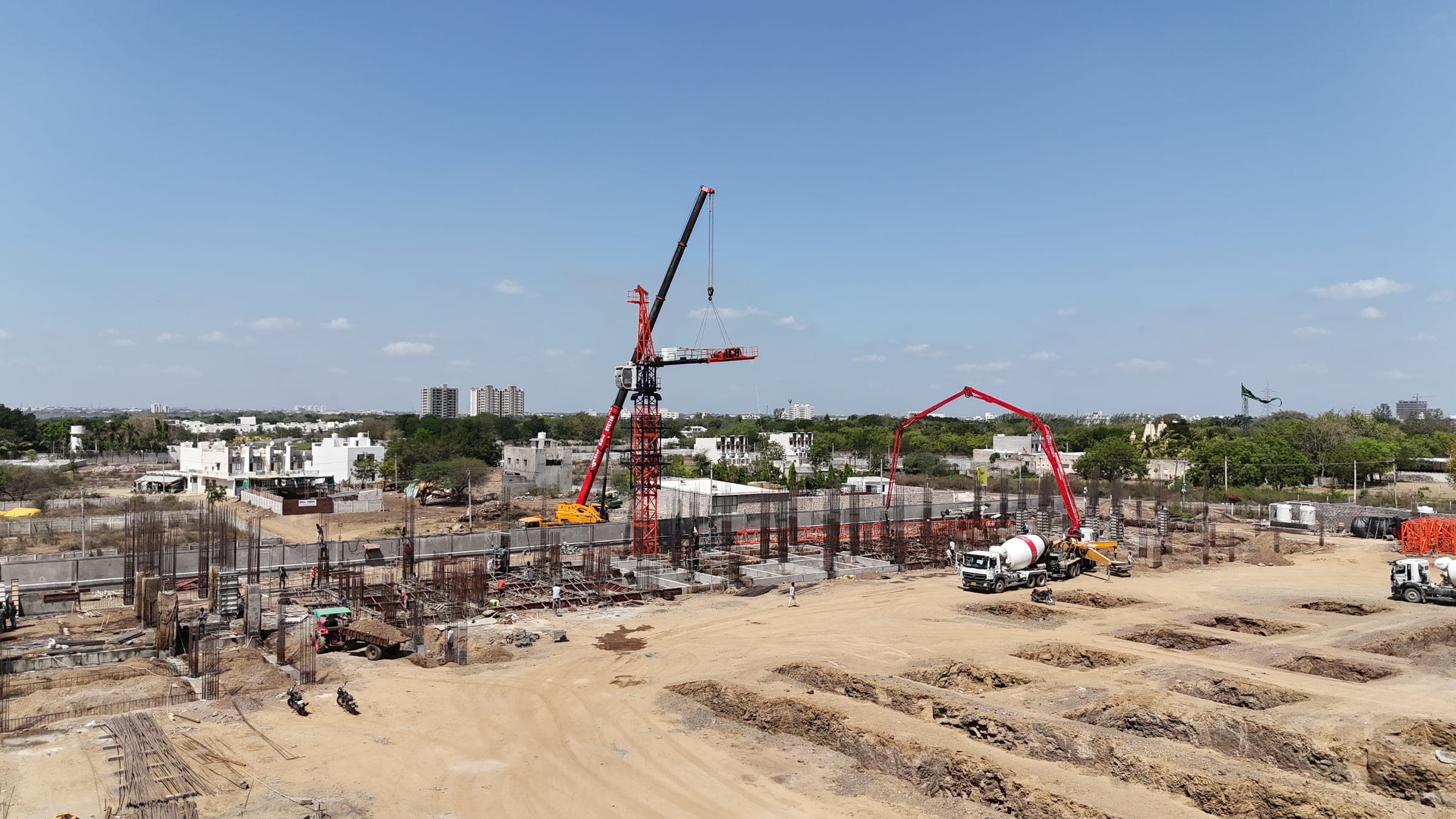 Mishwa Infra India construction site with tower crane, structural columns and reinforcement in progress